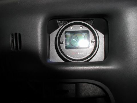 2002 Pontiac Grand Prix - A close-up view of an Aeroforce gauge mounted in the dashboard of a vehicle. The gauge has a digital display and is surrounded by a black b…
