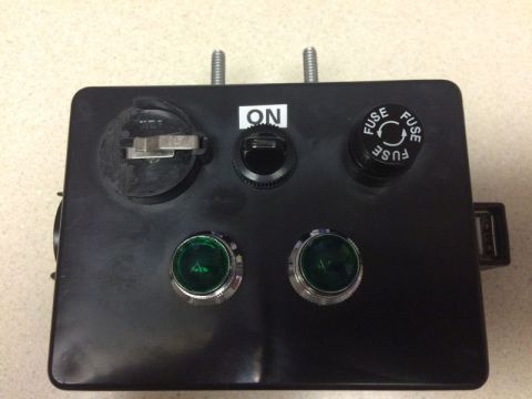 2002 Pontiac Grand Prix - A black electrical box with two green indicator lights, a toggle switch labeled ON, and two fuse holders. The box has two threaded bolts pr…