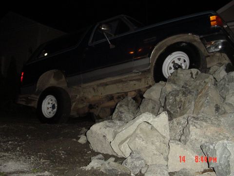 1987 Ford Bronco - This 1987 Ford Bronco is shown off-road, climbing over a pile of large rocks.