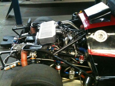 2002 Pontiac Grand Prix - Close-up view of the engine bay of a race car, showing the intercooler, turbocharger piping, and various hoses and fittings. The vehicle ha…