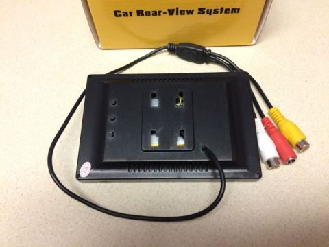 2002 Pontiac Grand Prix - The back of a car rear-view system monitor is shown, featuring RCA input connectors and a power cable. A yellow, red, and white RCA cable a…