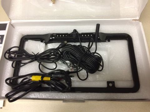 2002 Pontiac Grand Prix - A new license plate frame with a built-in backup camera and LED lights is shown in its packaging. The frame includes various cables for con…