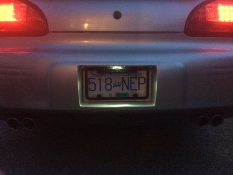 2002 Pontiac Grand Prix - Dusk shot, license light on. The frame blocks the license light.