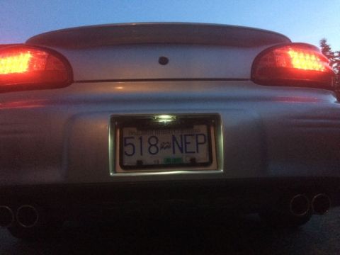 2002 Pontiac Grand Prix - Dusk shot, license light on. The frame blocks the license light.