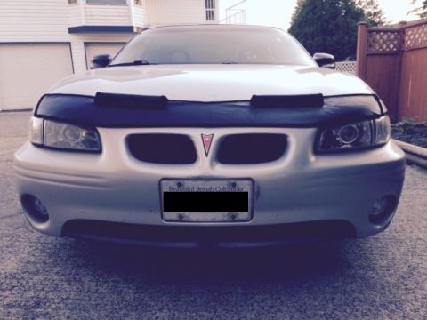 2002 Pontiac Grand Prix - The front view of a silver Pontiac Grand Prix with a black car bra covering the hood. A license plate reading "Beautiful British Columbia"…