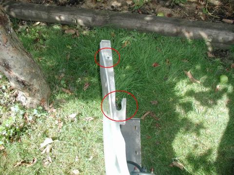 2002 Pontiac Grand Prix - The top hole is the "hidden" 10mm bolt. The lower "U" shaped part slides into a tab on the fender.