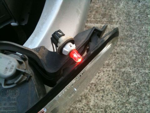 2002 Pontiac Grand Prix - A close-up view of a red LED bulb installed in a vehicle's taillight assembly. The assembly appears to be detached from the vehicle, showin…