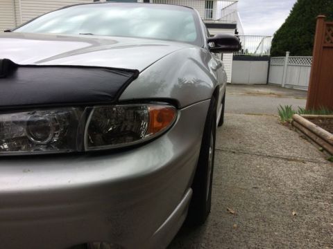 2002 Pontiac Grand Prix - Aftermarket headlight housings, stock brackets and aftermarket clear corners. Sag same as clear corners.