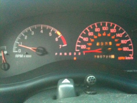 2002 Pontiac Grand Prix - The image shows a close-up of a car's dashboard, focusing on the speedometer and tachometer. The speedometer reads approximately 25 mph, an…