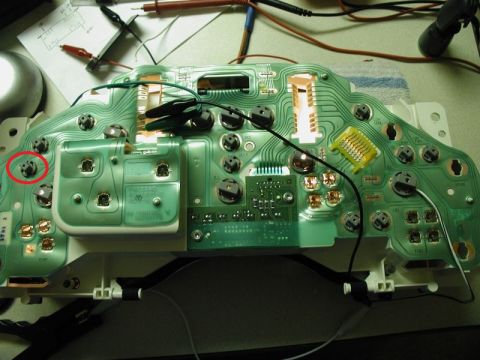 2002 Pontiac Grand Prix - The back of a green circuit board, likely from a car's instrument cluster, is shown with various electrical components and wires attached.…
