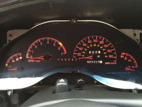 2002 Pontiac Grand Prix - The dashboard of a Pontiac Grand Prix shows a lit-up instrument cluster with a speedometer, tachometer, fuel gauge, and temperature gauge.…