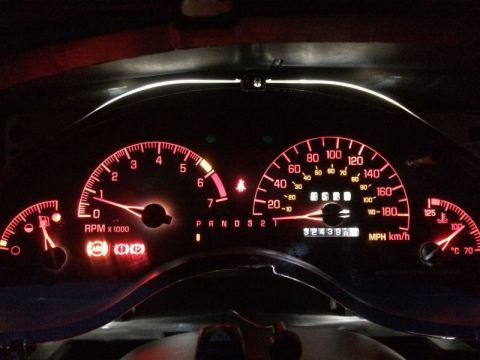 2002 Pontiac Grand Prix - Car on, dash lights on, signals dimly lit.