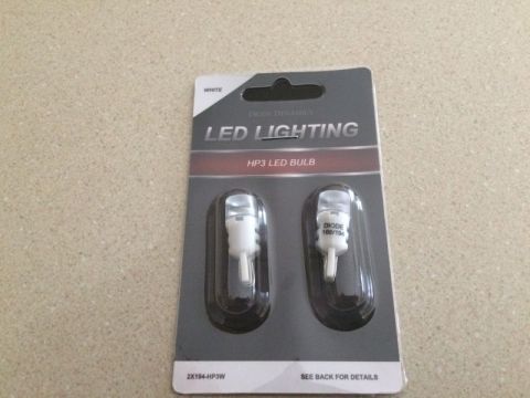 2002 Pontiac Grand Prix - A blister pack containing two white Diode Dynamics HP3 LED bulbs is shown against a speckled countertop. The packaging indicates "LED LIGHT…