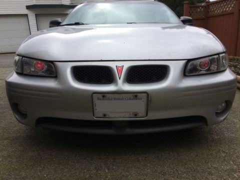 2002 Pontiac Grand Prix - Ran the wires for the demon eyes; went through the firewall at a grommet to the left of the steering column, got chassis ground from a stud…