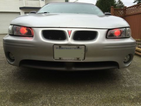 2002 Pontiac Grand Prix - Ran the wires for the demon eyes; went through the firewall at a grommet to the left of the steering column, got chassis ground from a stud…