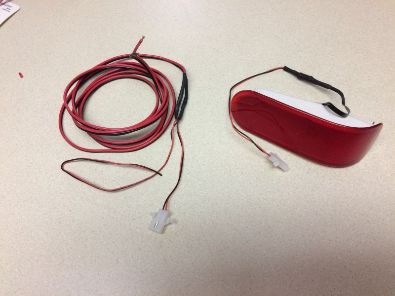 Wire harness to run in the door. It splits to a plug for the door light, and the other end is for some future door handle lighting.