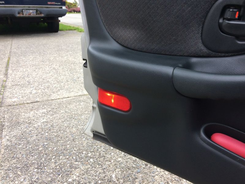 Left front, door re-assembled, wiring run to kick panel, lit with power supply.