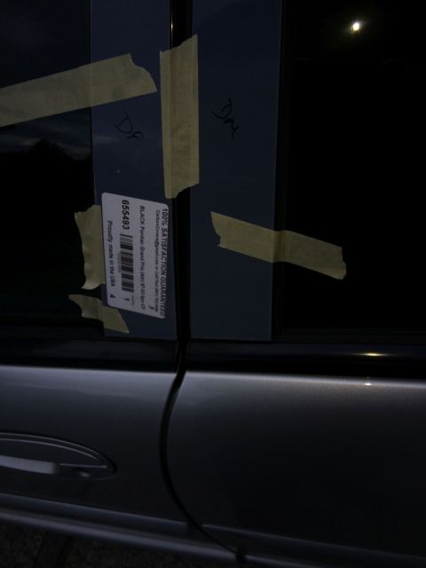 2002 Pontiac Grand Prix - A close-up view of a car door with a label that reads "100% SATISFACTION GUARANTEED" and "Proudly made in the USA" is taped to the window.