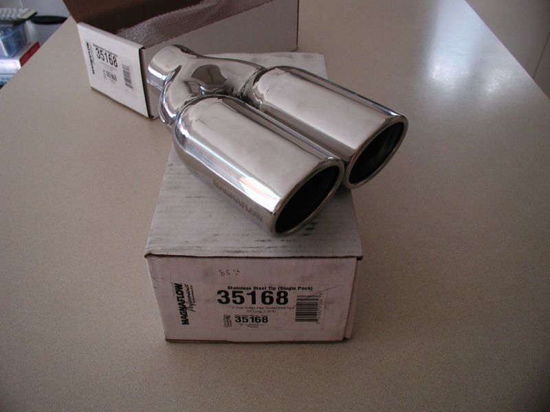 Polished chrome dual exhaust tip on its Magnaflow packaging box.