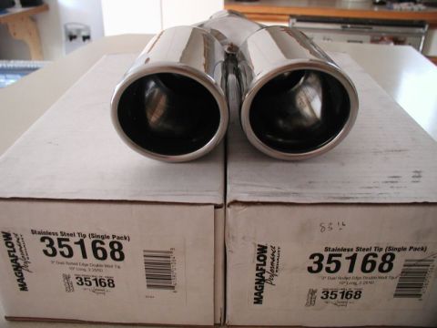 2002 Pontiac Grand Prix - Two Magnaflow stainless steel exhaust tips are shown resting on top of their original packaging boxes. The boxes are labeled 'Stainless Ste…