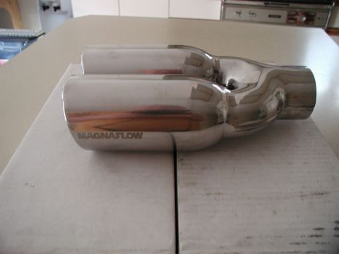 2002 Pontiac Grand Prix - A polished metal Magnaflow dual exhaust tip with the brand name etched into the side is shown on a white surface.