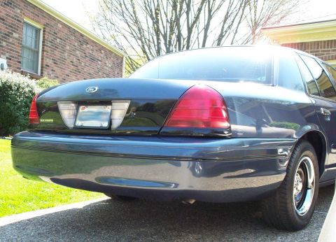 1998 Ford Crown Victoria - Rear view of a dark blue 1998 Ford Crown Victoria parked in a driveway.