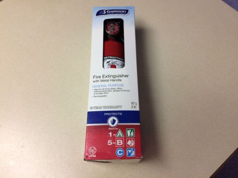 2002 Pontiac Grand Prix - A box for a Garrison fire extinguisher is shown on a table.