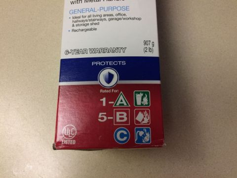 2002 Pontiac Grand Prix - This is a close-up of a fire extinguisher box. The box shows "GENERAL-PURPOSE", "6-YEAR WARRANTY", and fire rating symbols.