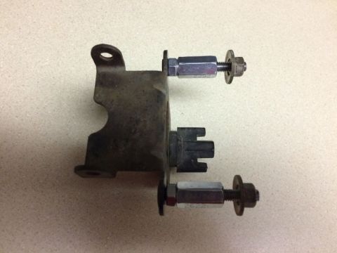 2002 Pontiac Grand Prix - This is a close-up of a metal bracket with two bolts and nuts attached. One bolt has a washer and a castle nut, while the other has a washe…