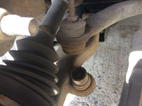 2002 Pontiac Grand Prix - This is a close-up view of the suspension components of a vehicle, specifically focusing on a tie rod end and a CV boot. The parts appear t…