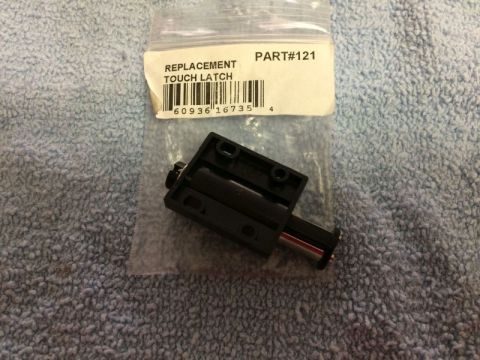 2002 Pontiac Grand Prix - A black touch latch part in its original packaging is shown against a blue textured background. The label on the packaging reads "REPLACEME…