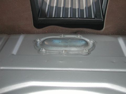 2002 Pontiac Grand Prix - Pull back the carpet in the trunk to expose the access panel.