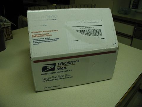 2002 Pontiac Grand Prix - A USPS Priority Mail Large Flat Rate Box is shown sitting on a light-colored countertop.