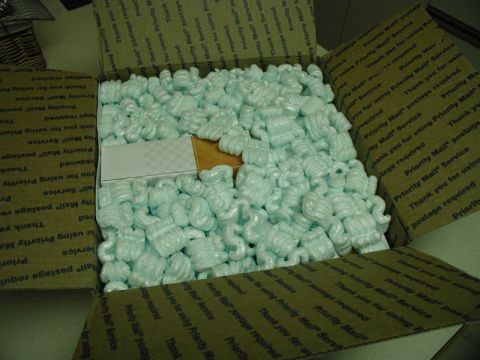 2002 Pontiac Grand Prix - An open cardboard box filled with packing peanuts. A small white and checkered box is visible underneath the peanuts.