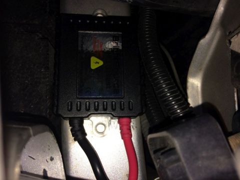 2002 Pontiac Grand Prix - A black ballast with yellow warning sticker and text is visible, connected to black and red wires. The ballast is mounted in what appears t…
