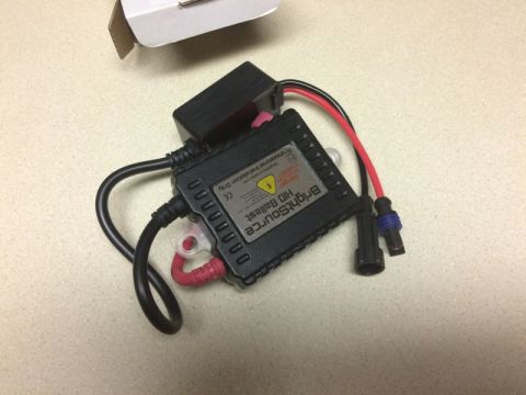 2002 Pontiac Grand Prix - A black BrightSource HID ballast with red and black wires is shown on a speckled countertop next to a partially visible white box.