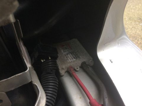 2002 Pontiac Grand Prix - A close-up view of a ballast and wiring harness, likely for a vehicle's lighting system, is visible within a dark compartment.