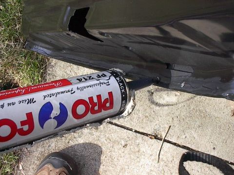 1986 Ford Bronco - Sealing up the crimped edges on the new door shells. It's sandable and paintable and drys real quick. Push it into the seams pretty quick.