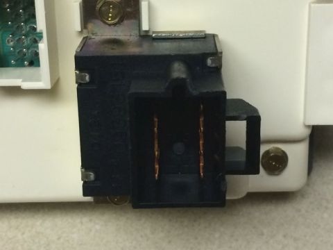 2002 Pontiac Grand Prix - A close-up view shows a black electrical connector with copper terminals attached to a white plastic housing. Text is visible on the side o…