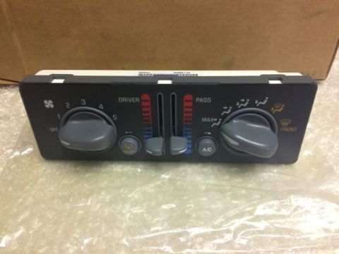 2002 Pontiac Grand Prix - A close-up view of a car's climate control unit with two large gray knobs and vertical sliders for temperature control. The unit displays l…