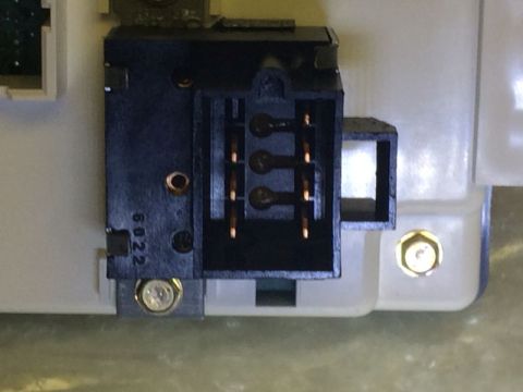 2002 Pontiac Grand Prix - A close-up view shows a black electrical connector with six copper pins protruding from a white plastic housing. The connector is secured b…