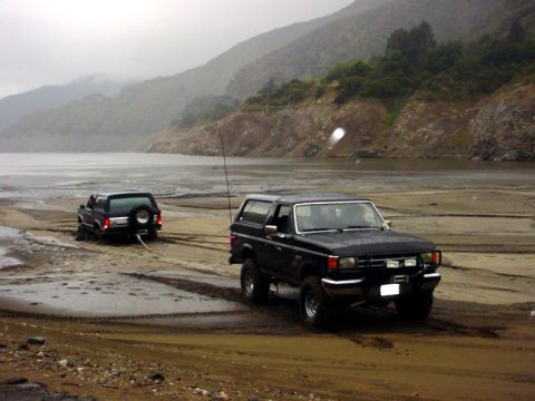 1988 Ford Bronco - I tried to tug him out, but my bronco was too weak. I ended up turning around and winching him with a snatchblock, matt anchored.