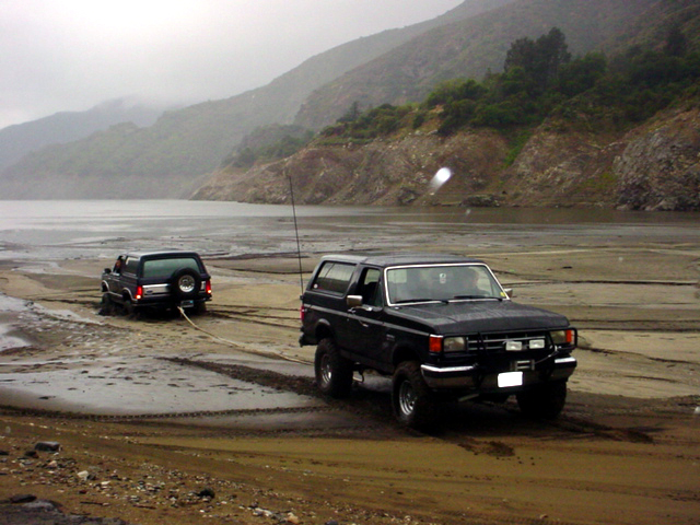 I tried to tug him out, but my bronco was too weak.  I ended up turning around and winching him with a snatchblock, matt anchored.