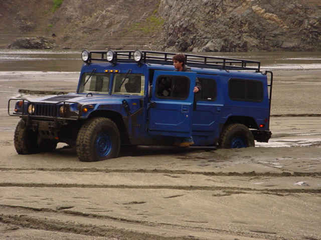 This kid got his daddy's hummer stuck in some soft sand.  When he first got stuck he told US to walk over to HIM.  He finally came over and asked if he could use our winches, we told him no since we wanted to see a good show.  I big dodge finally yanked him out.