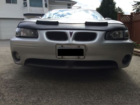 2002 Pontiac Grand Prix - The front view of a silver Pontiac Grand Prix shows its headlights, grille, and a license plate that reads "Beautiful British Columbia". A…