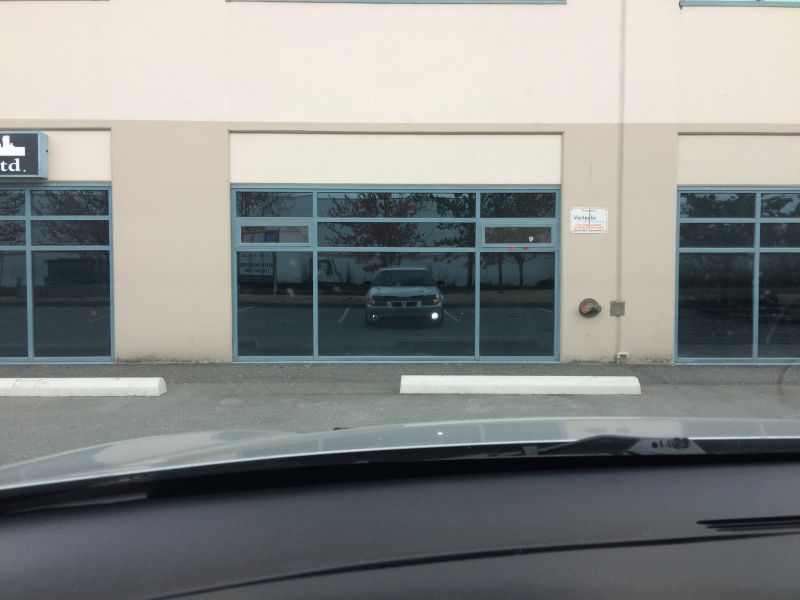 Silver van reflected in building windows