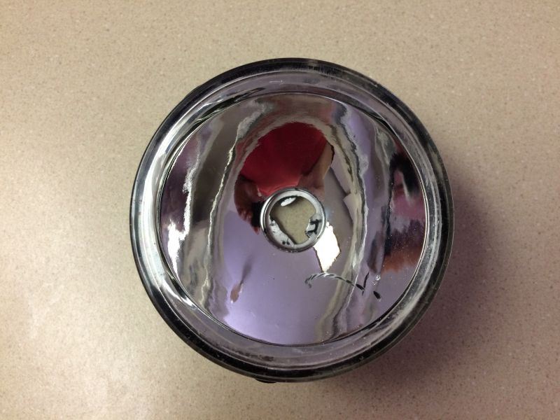 Factory lens trimmed to fit.