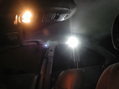 2002 Pontiac Grand Prix - The interior of a car is shown with bright LED lights illuminating the ceiling and rear passenger area. Visible elements include the headli…