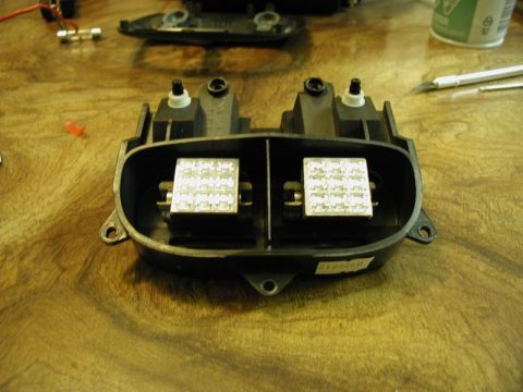 2002 Pontiac Grand Prix - A close-up view of a black plastic housing containing two square circuit boards populated with many small LEDs. The housing is resting on a…