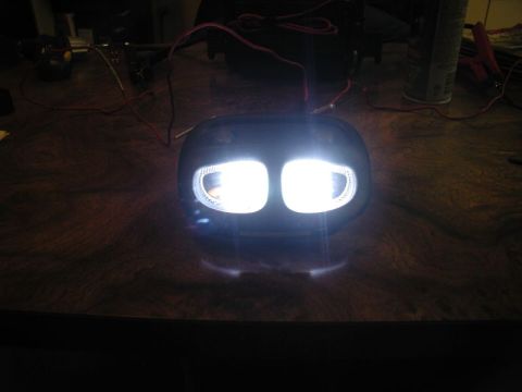 2002 Pontiac Grand Prix - A pair of bright LED headlights are wired up and illuminated, sitting on a wooden surface. The headlights appear to be part of a custom mod…